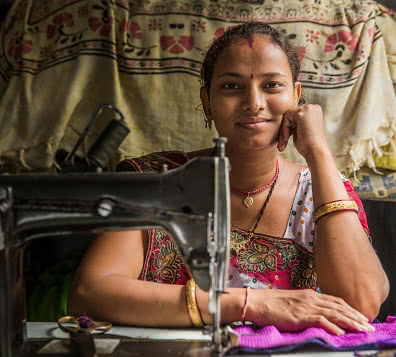home-based apparel worker at sewing machine, Ahmedabad, India