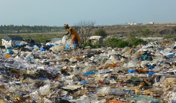 Woman working at Mbeubeuss landfill, Dakar