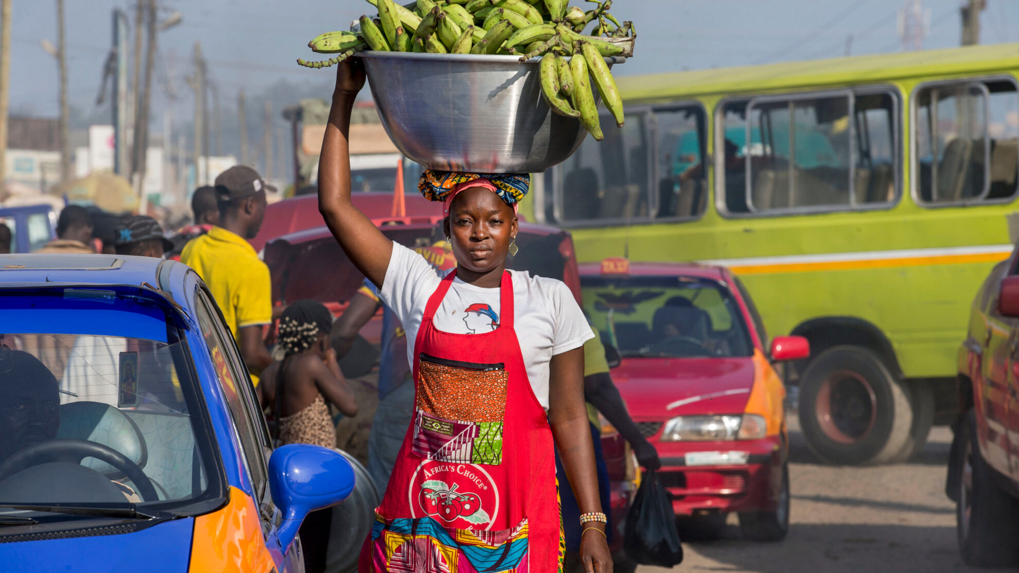 Mamuna Mohammed, a head load porter (kayayei), carries bananas through Agbogbloshie Market in Accra, Ghana