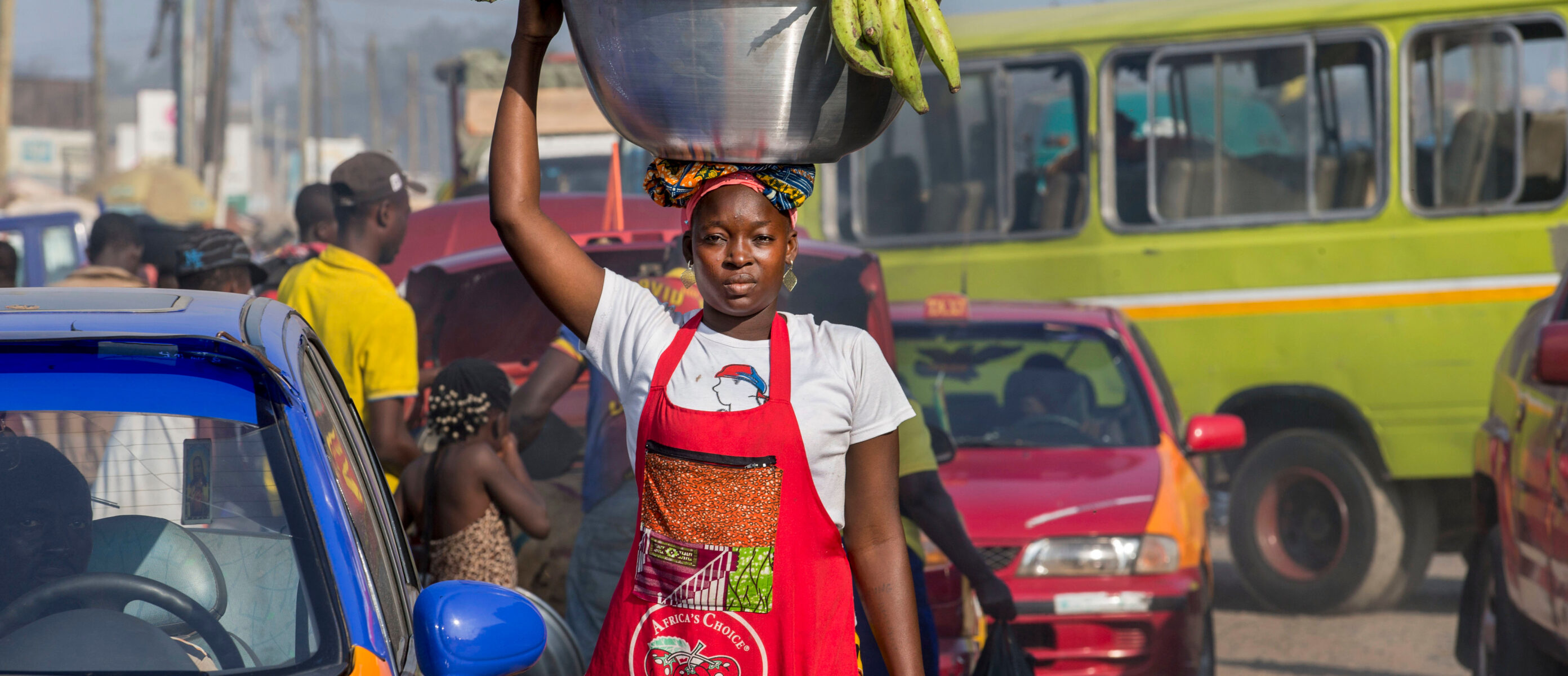 Mamuna Mohammed, a head load porter (kayayei), carries bananas through Agbogbloshie Market in Accra, Ghana