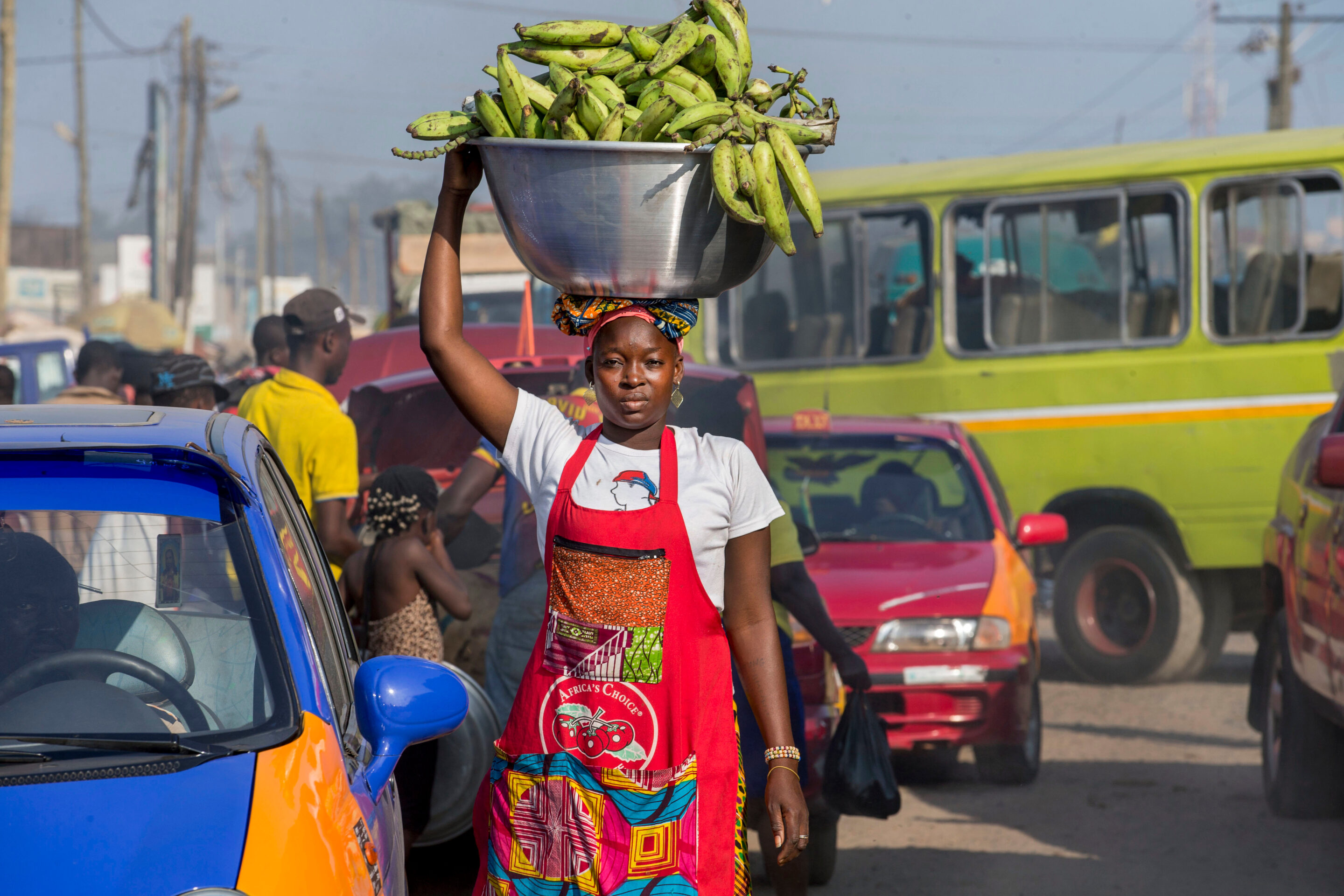 Mamuna Mohammed, a head load porter (kayayei), carries bananas through Agbogbloshie Market in Accra, Ghana