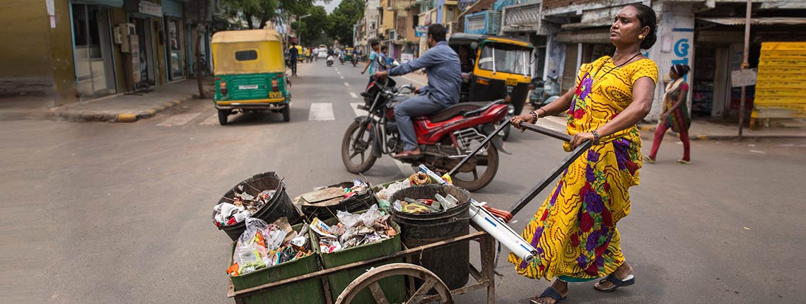 Sangeeta Ben walks her daily route working as a waste picker in an Ahmedabad slum