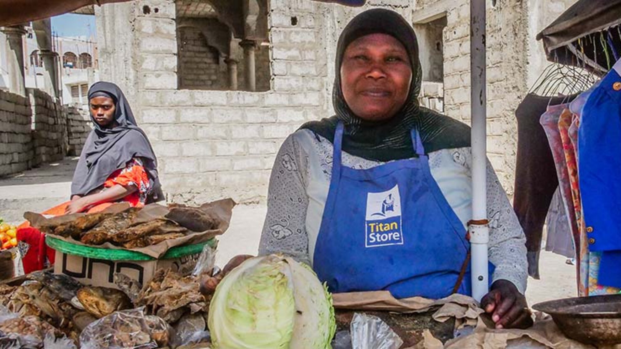 Salimata Traore, a street vendor, at her market stall with textiles and groceries in Grand Yoff