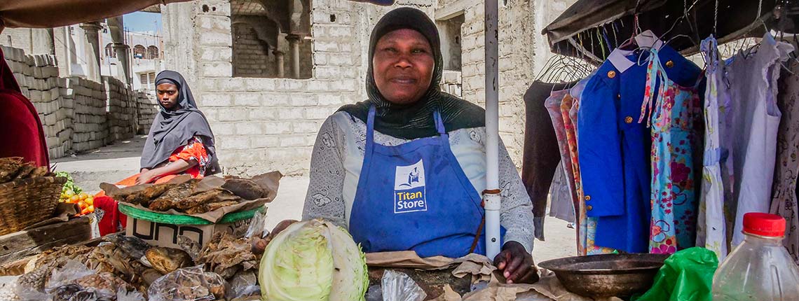 Salimata Traore, a street vendor, at her market stall with textiles and groceries in Grand Yoff