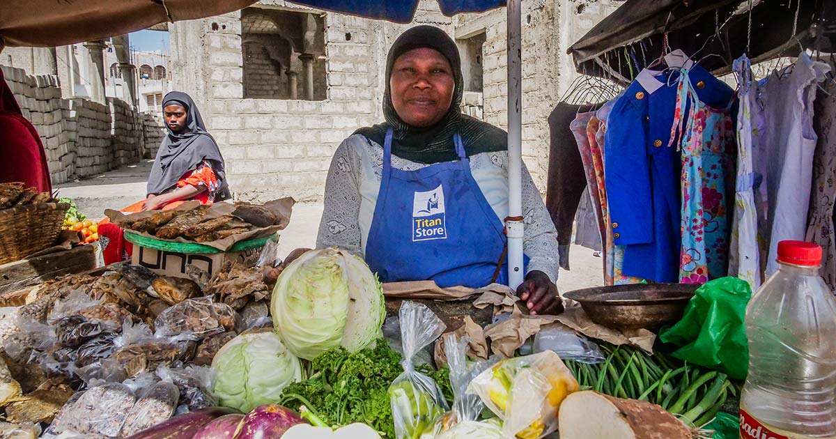 Salimata Traore, a street vendor, at her market stall with textiles and groceries in Grand Yoff