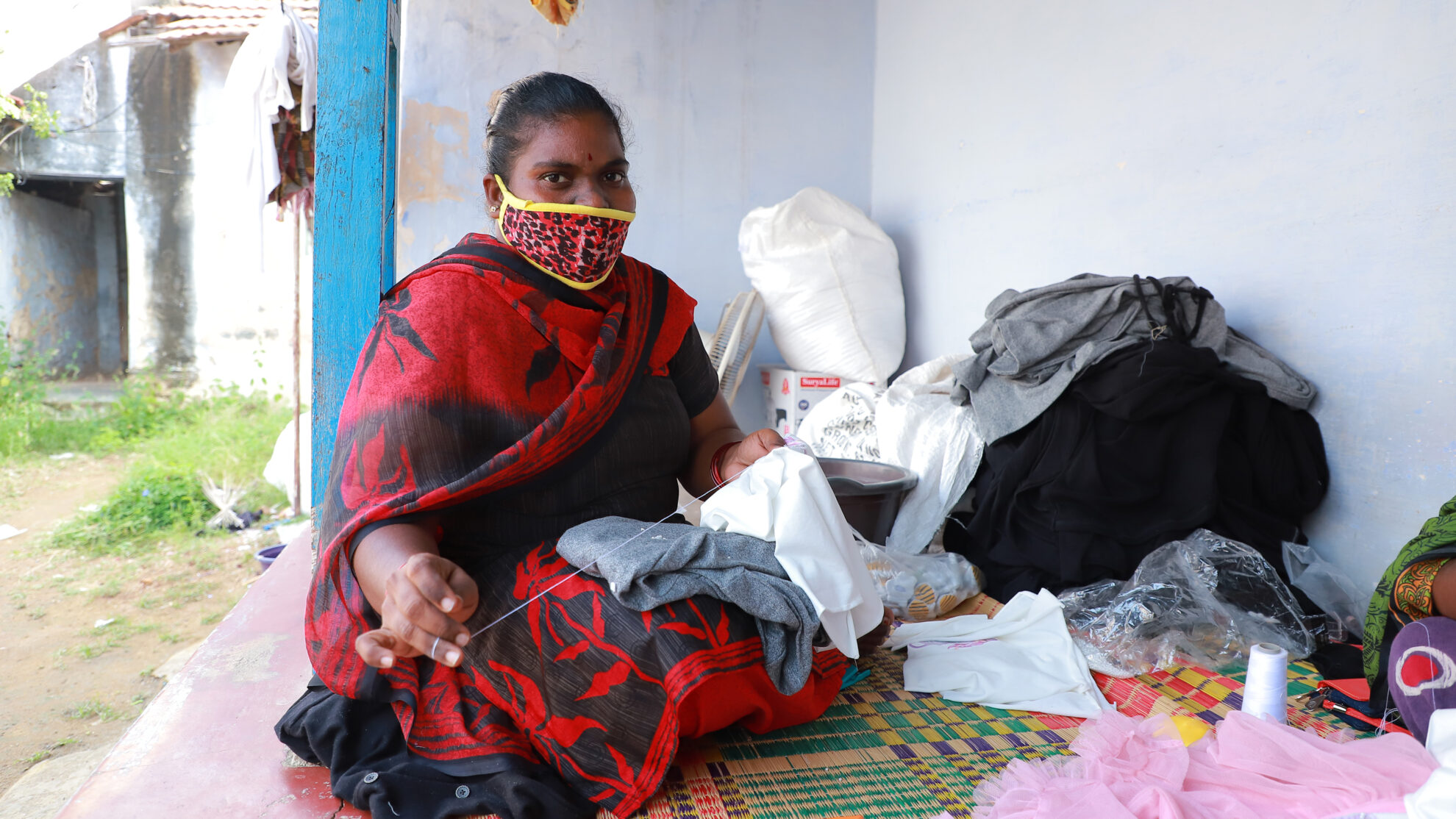 A garment worker stitches in Tiruppur, India, during the Covid-19 pandemic