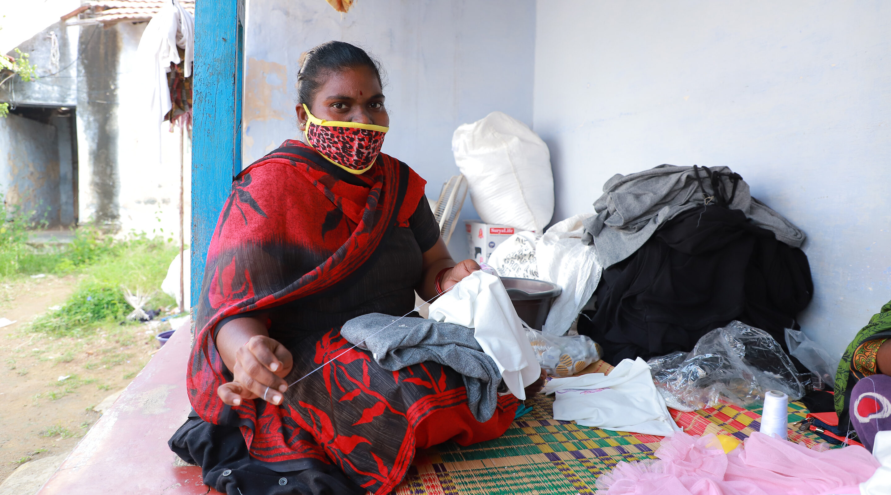 A garment worker stitches in Tiruppur, India, during the Covid-19 pandemic