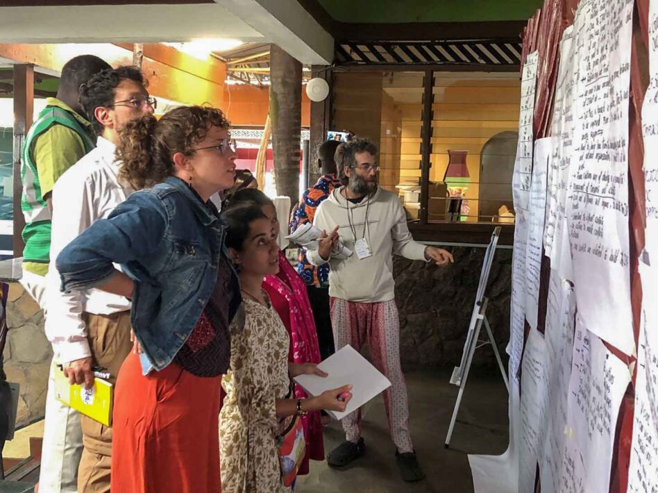 Members of the International Alliance of Waste Pickers participate in an organizational mapping and visioning workshop in February 2023, reviewing notes posted on a wall.