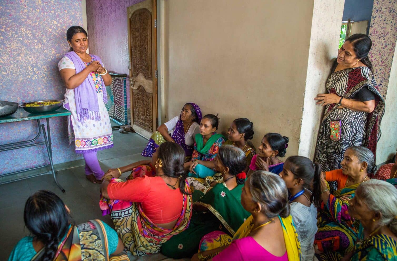 Padma, a SEWA representative, speaks to a group of mothers during a nutrition programme at the BALSEWA Center, which provides essential services for women workers in the informal sector.