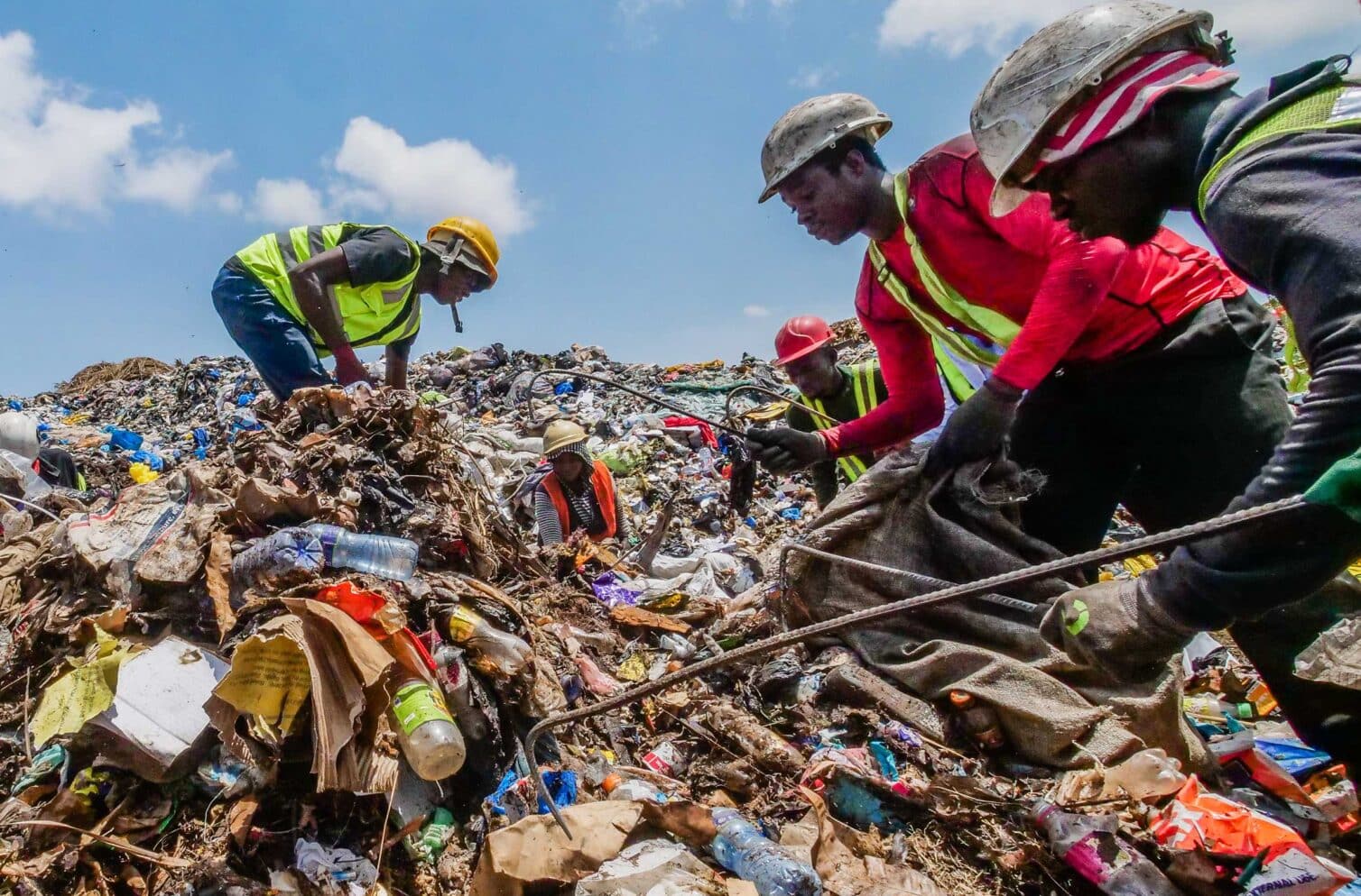 Waste pickers sorting through garbage at Kpone Landfill in Accra, Ghana.